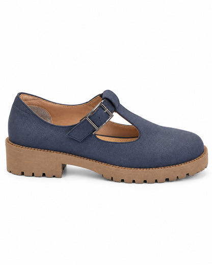 Side profile of the VIVACE Marielle navy T-bar shoe, showing its textured upper, tan lug sole and low wide heel.